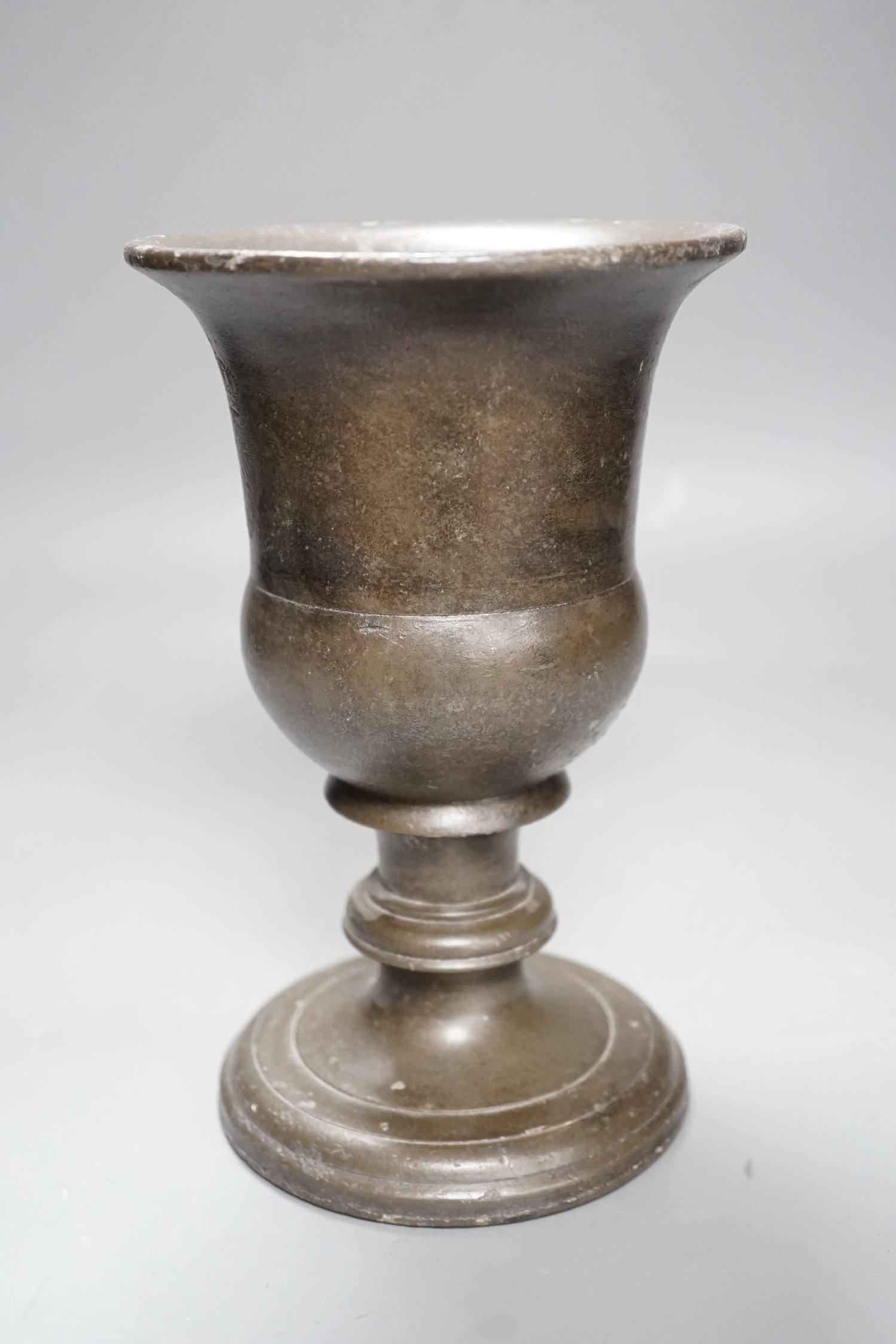 A bronzed cast iron urn, 22cm